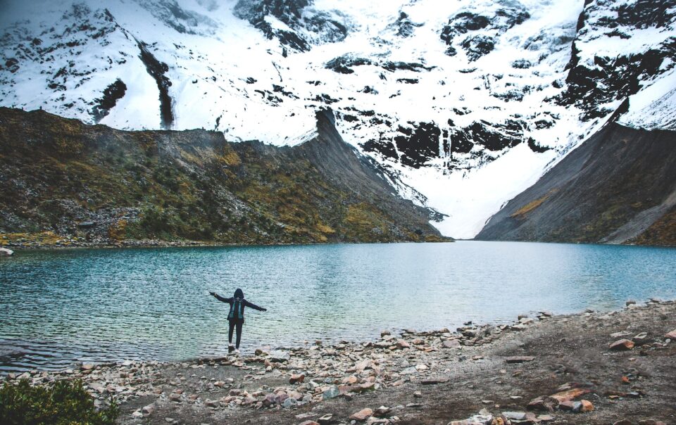 person standing near lake at daytime